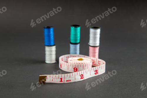 Preview: front view pink centimeters with threads on dark background darkness pin sewing measure photo color