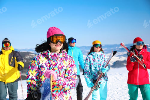 Preview: Young woman with snowboard at ski resort. Winter vacation