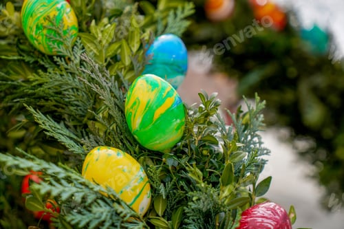 Preview: Selective focus of colorful Easter eggs on a tree in a park