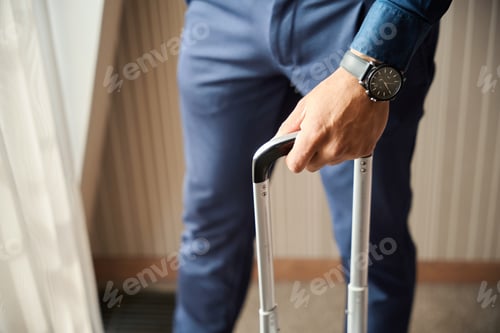 Preview: Close up of african american businessman hand with suitcase standing by window