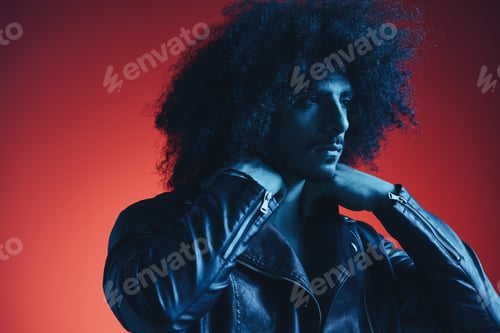 Preview: Portrait of fashion man with curly hair on red background multinational, colored light, black