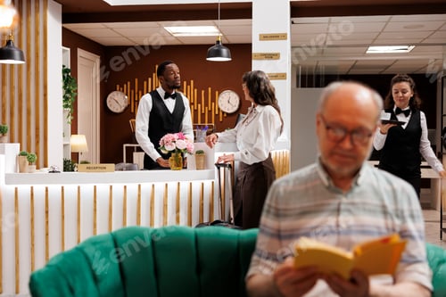 Preview: Elderly woman talks to hotel concierge