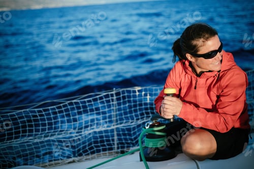 Preview: Attractive strong woman sailing with her boat