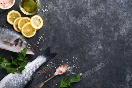 Preview: Sea Bass raw. Fresh sea fish bass with salt, pepper, parsley, olive oil and lemon on dark concrete r