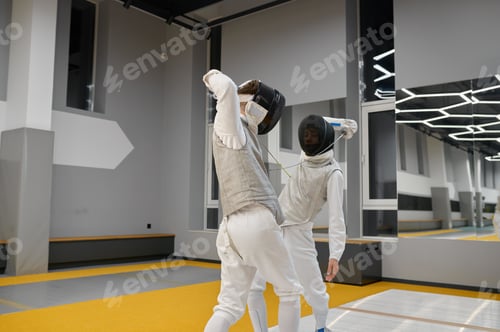 Preview: Two fencers exercising movements in duel at fencing room