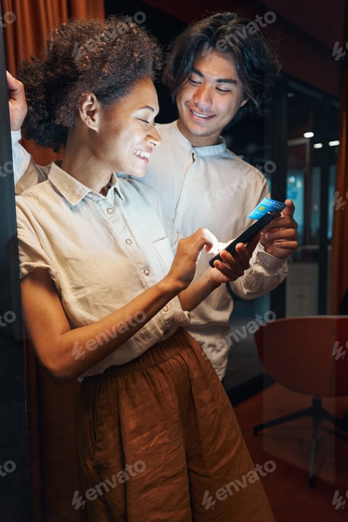 Preview: Smiling man having break with colleague in corridor