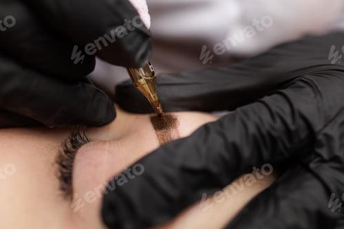 Preview: Macro photo introduction of pigment into the skin with a tattoo machine eyebrow correction