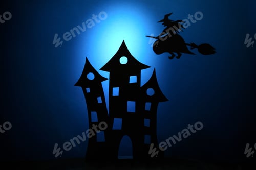 Silhouette Witch Flying over Spooky Haunted House
