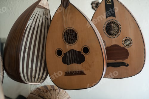 Preview: Closeup shot of multiple ouds hanging on a wall
