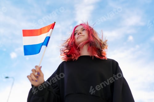 Preview: Student girl teenager with the flag of the Netherlands in hand