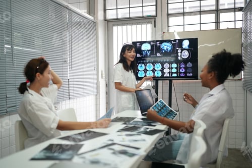 Preview: Group of doctors looking at X-ray on medical conference, discussing issues