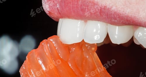 Preview: Close-up orange in the woman's mouth