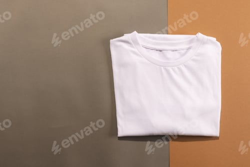 Preview: Close up of folded white t shirts and copy space on brown background