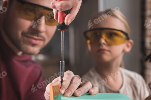Preview: Father showing how to use screwdriver to his daughter