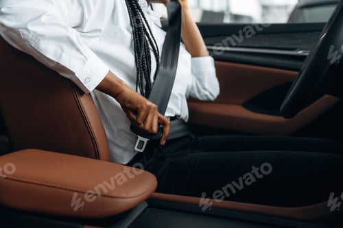 Preview: Safety first. Woman in white shirt is in the modern car