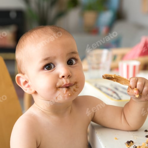 Preview: A one year old baby eating cake on his first birthday