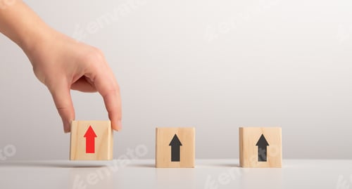 Preview: Female Hand Putting Wooden Blocks With Arrows Up, Gray Background