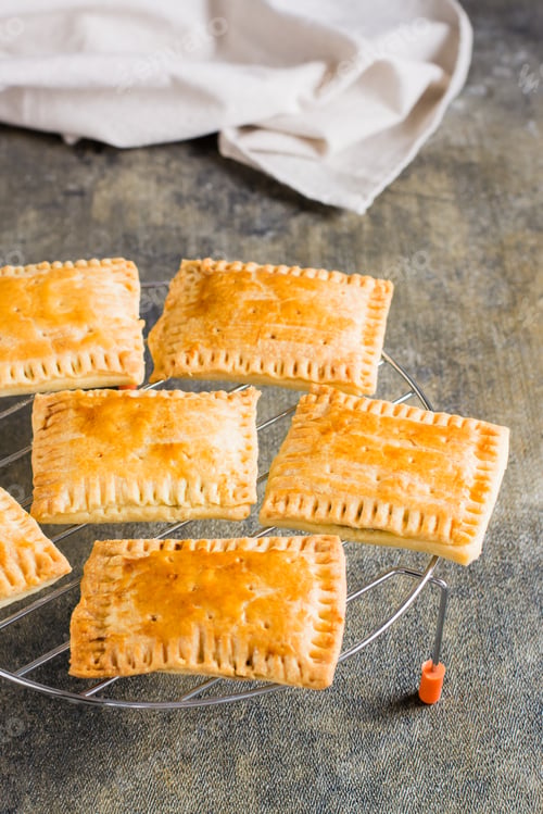 Preview: Homemade pop tarts made from scratch on the grid on the table. Vertical view