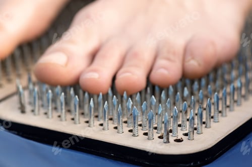 Preview: A woman standing on nails