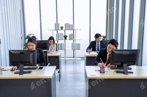 Preview: Business employee in formal suits working at table and discussing business strategy together