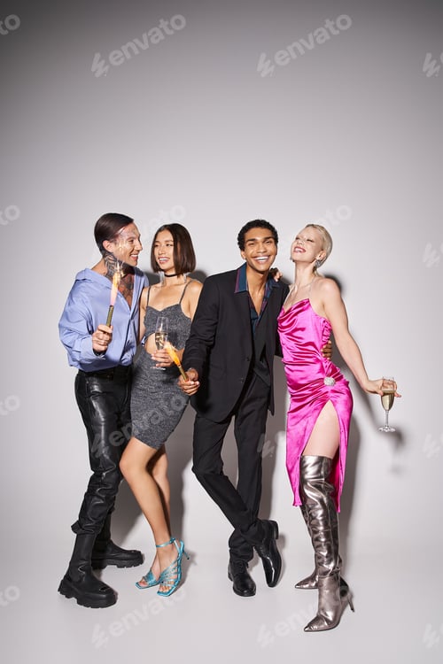 Preview: group of happy multiethnic friends holding champagne and sparkles while celebrating New year 2024