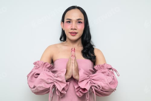 Preview: Portrait of a young Thai transgender person against white background greeting