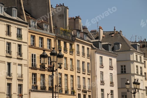 Preview: Classic European buildings with street lamps on a clear day.
