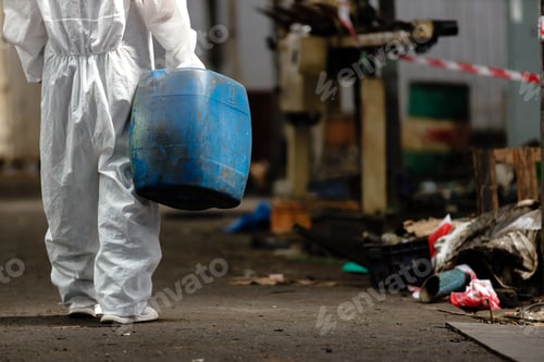 Preview: Inspector female worker hazmat suit holding chemistry tank in industrial.