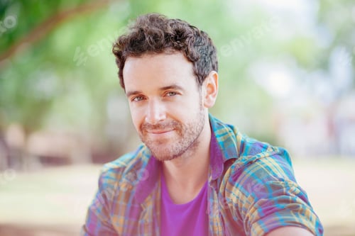 Preview: Portrait of mid adult man wearing checked shirt looking at camera smiling