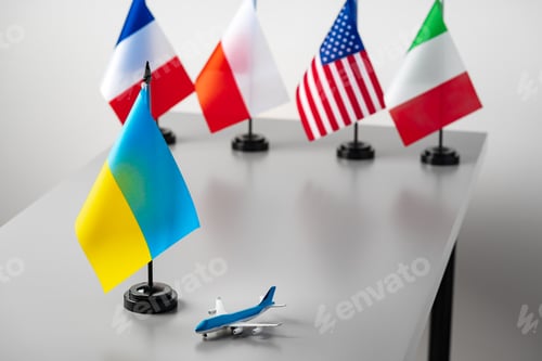 Preview: Flags and toy airplane close up. Travel concept