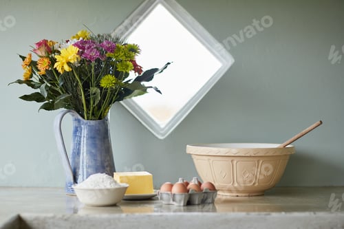 Preview: Shot of a counter with baking ingredients arranged on it in a country kitchen