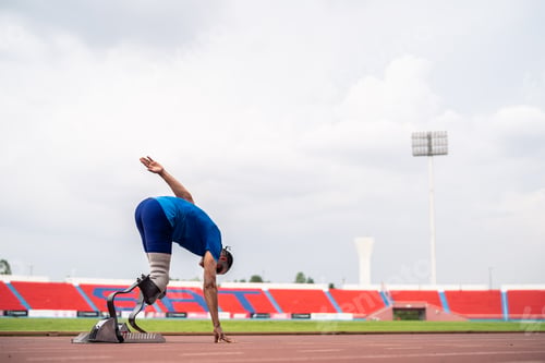 Preview: Asian para-athletes disabled with prosthetic blades running at stadium.