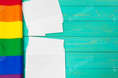 Preview: Bright rainbow gay flag on wooden background and blank space