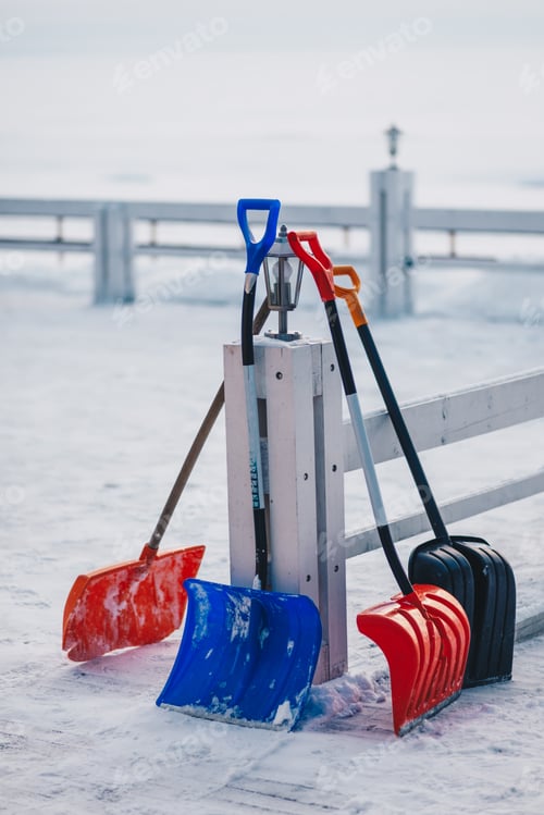 Preview: Vertical outdoor shot of plastic scoop for removing snow. Shovel in snow