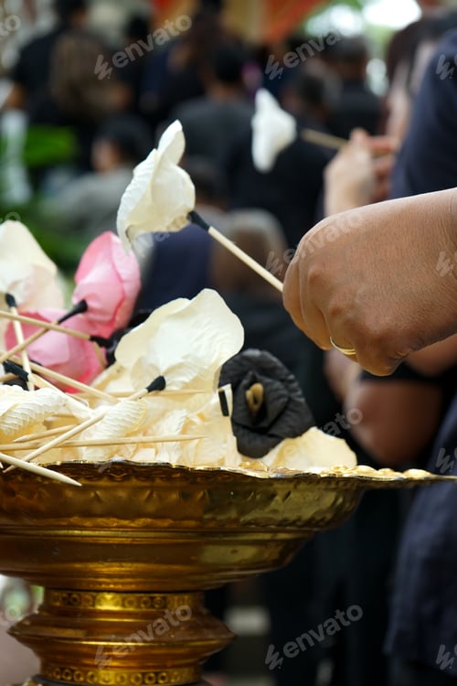 Preview: Hand of people picks up the paper flower from the tray during funeral in Buddhism temple