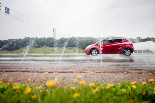 Preview: Water spraying on red car on road