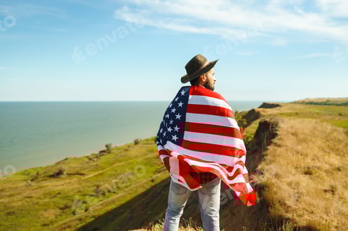 Preview: Traveler with the flag of America. The man in a hat, a backpack