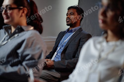 Preview: Black Male Conference Participant Attending Business Meeting in Auditorium
