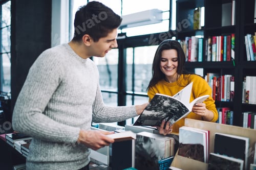 Preview: Positive couple turning pages of book in store