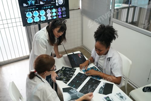 Preview: Group of doctors looking at X-ray on medical conference, discussing issues