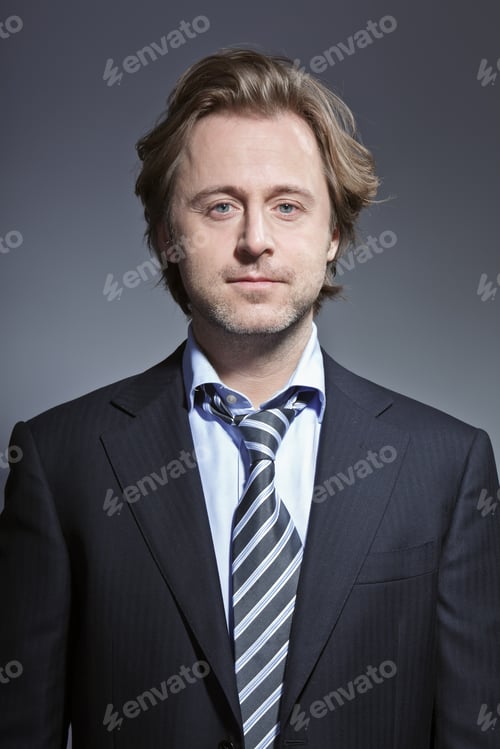 Preview: Studio Portrait Of Young Business Man Smiling. Suit And Tie.