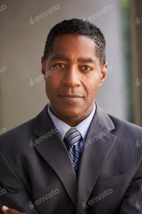 Preview: Middle aged black businessman looking at camera, vertical