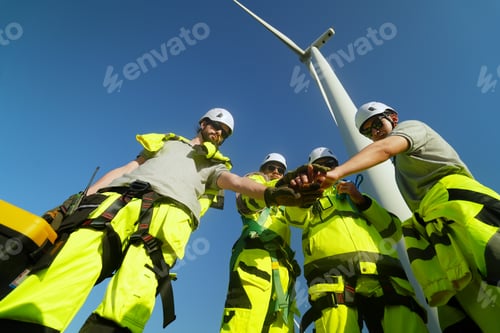 Preview: Wind turbine inspector wearing Personal protective equipment working at wind turbines farm.