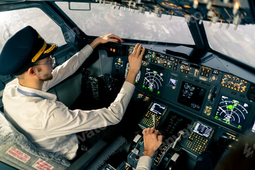 Preview: young pilots in the cockpit of the plane control air transport during long distance flight simulator