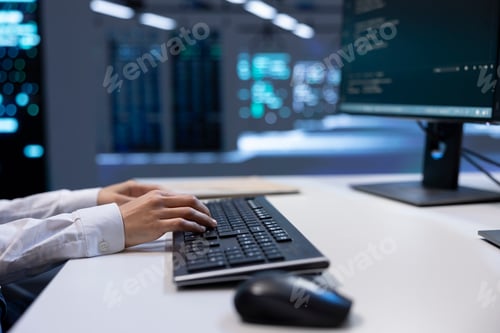 Preview: Close up of engineer in data center typing on keyboard