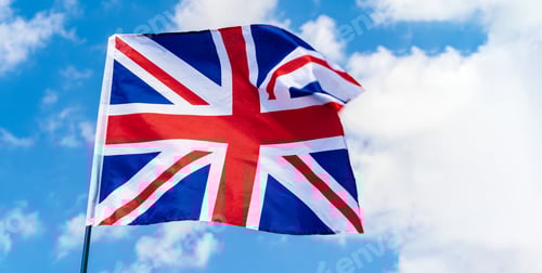 Preview: United Kingdom Flag waving on wind in blue sky