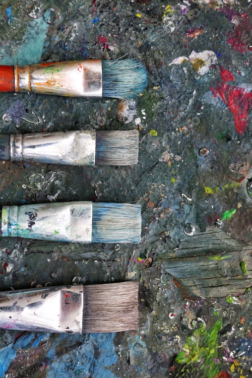 Preview: Colorful brushes on a dirty paint palette