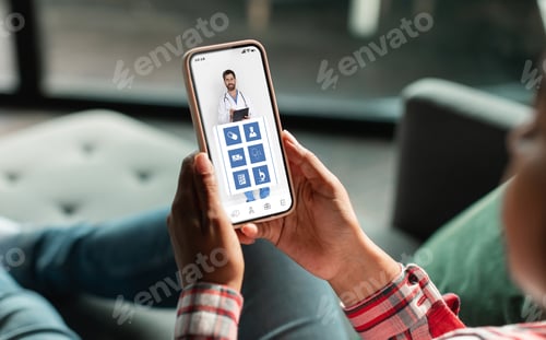 Preview: Unrecognizable woman browsing healthcare app on her smartphone at home