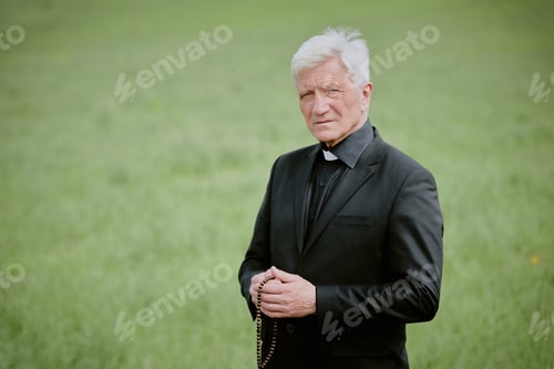 Preview: Portrait of Senior Caucasian Man Holding Rosary Standing Outdoors at Funeral