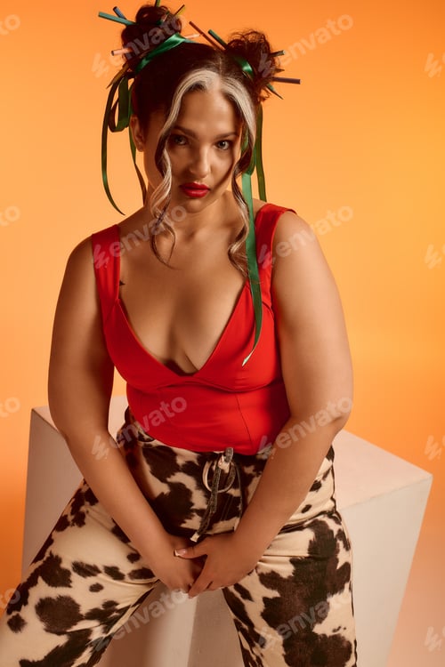 Preview: Young woman's bold style shines with unique features against a vibrant backdrop
